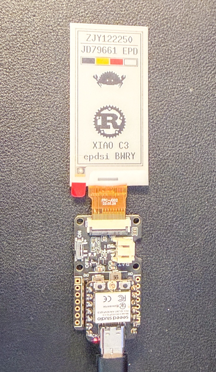 The same XIAO ESP32-C3 and ePaper Driver Board from the failure photographs, now rendering a 2.13 inch quad-colour panel correctly in black, white, red and yellow